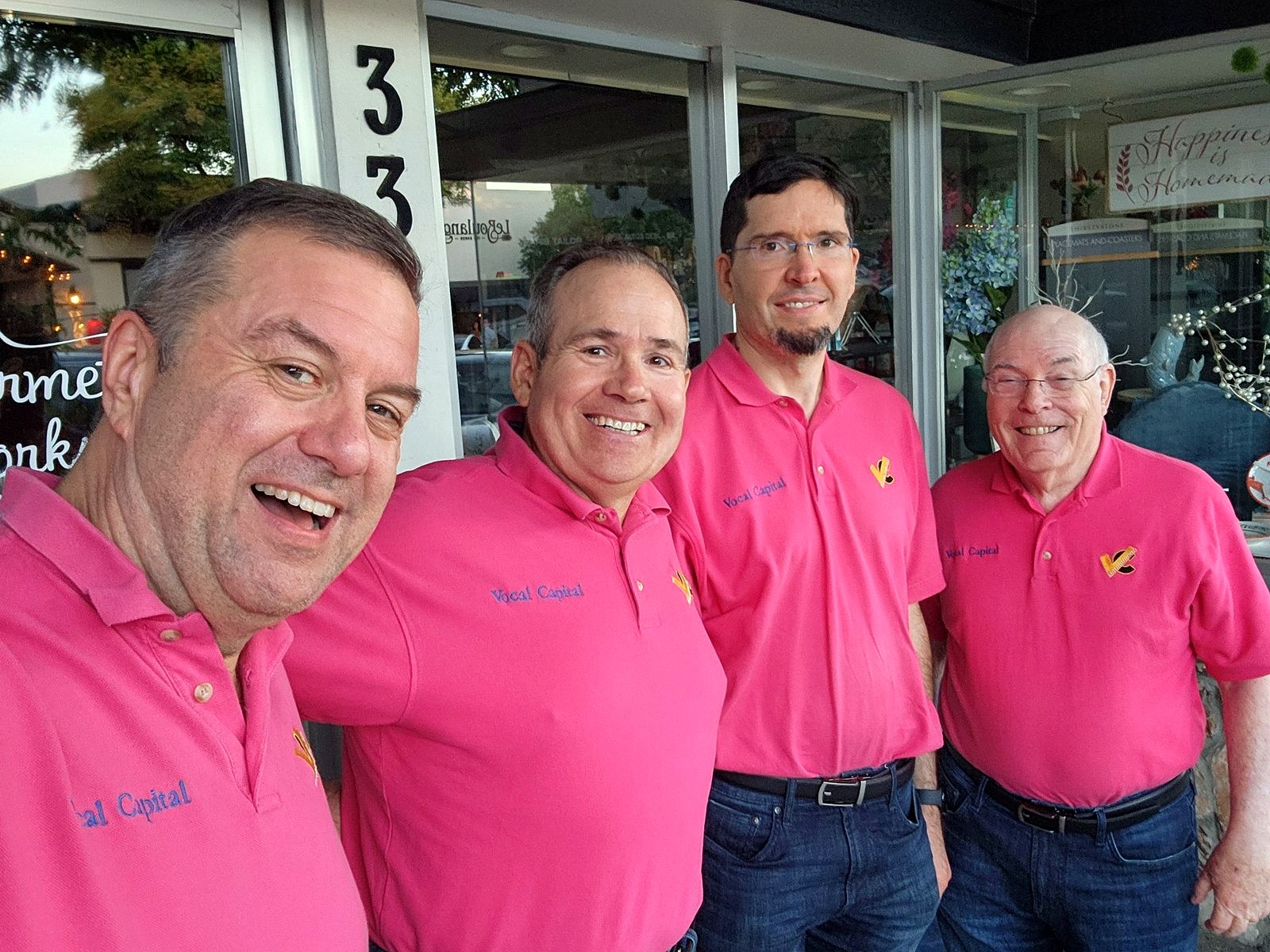 Vocal Capital quartet outside a Los Altos shop